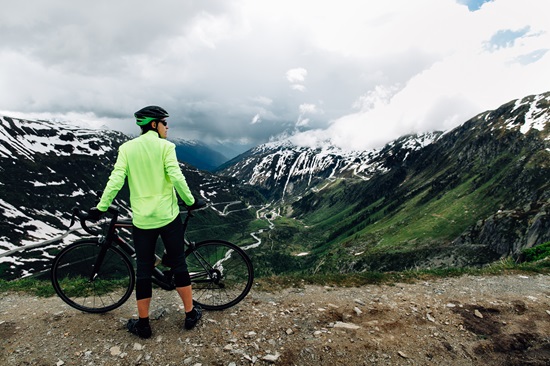 Cyclist standing with road bikes on background of beautiful Alpine mountains norway things to do